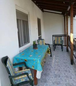 stół i krzesła na werandzie ze stołem w obiekcie Fanis & Xenia's Residence w mieście Samotraka
