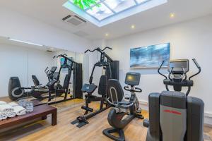 a gym with treadmills and exercise bikes in a room at Korner Opera in Paris