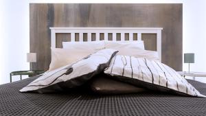 a bed with a blanket on top of it at SpAsimoH-2 in Palermo