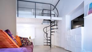 a loft bed in a room with a couch at SpAsimoH-2 in Palermo +3 photos
