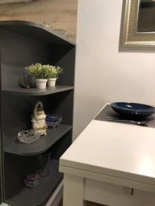 a kitchen with black shelves and a white table at Irena's Home away from home in Zagreb
