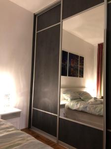 a large mirror in a bedroom with a bed at Irena's Home away from home in Zagreb