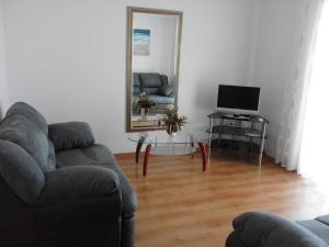 a living room with a couch and a mirror at Apartment Monika in Rovinj
