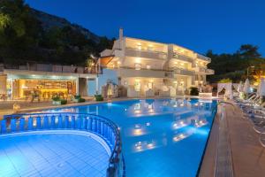 a large swimming pool in front of a house at Pefkos View Suites & Maisonette in Pefki