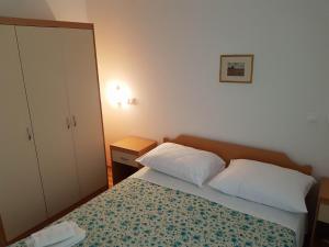 a small bedroom with a bed and a cabinet at Villa Mandina in Sevid +123 photos