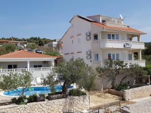a villa with a swimming pool and a house at Villa Mandina in Sevid