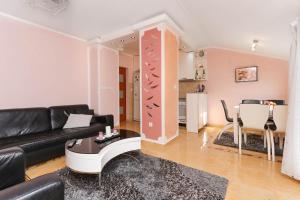 a living room with a black couch and a table at Apartment Sea View in Kotor