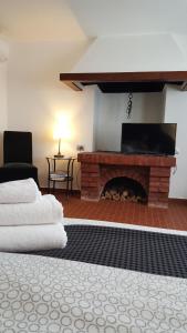 a living room with a brick fireplace and a chair at Casa del Vigneto - NEW near VENICE - rooms+bathroom - INDEPENDENT in Spinea