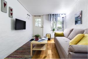 a living room with a couch and a table at Innergårdens Bed and Breakfast in Karlshamn