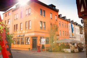 a large orange building on a city street at Neubert`s Gasthaus am Rhein in Lahnstein