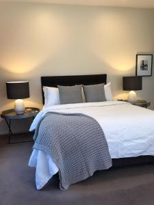 a hotel room with a bed and two nightstands at Daylesford Spa Villa One in Daylesford