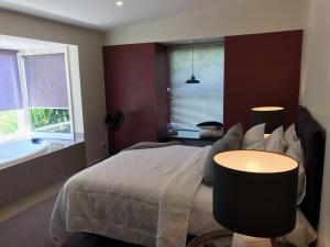a bedroom with a bed and a bath tub at Daylesford Spa Villa One in Daylesford