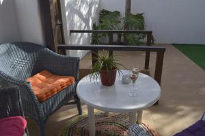 a table and a chair and a glass of wine at Tilama in Puerto del Rosario