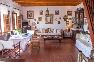 a living room with a couch and a table at Villa with majestic view in Patmos