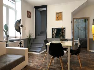 a living room with a table and chairs at Dunakavics Boutique Apartman Szentendre in Szentendre