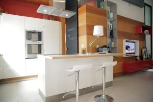 a kitchen with a counter and stools in a room at Loft Bordador in Seville