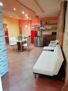 a living room with white furniture and a kitchen at Sole&Mare in Monopoli