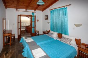 a bedroom with a blue bed in a room at Argyros house in Triopetra