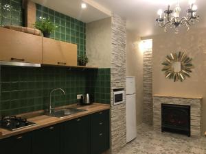 a kitchen with a sink and a fireplace at Софиевский квартал in Petropavlovskaya Borshchagovka