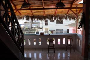 a view of a balcony with stools and a bar at La Jungla in Olón