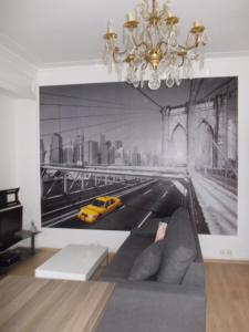 a living room with a wall mural of a city at Nationale Appart Hotel in Lille