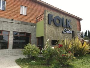 a building with a sign that reads joy smiles at Folk Suites in El Calafate