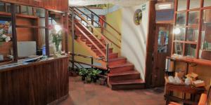 a hallway with a staircase in a building at Hotel COTURPA in Papallacta