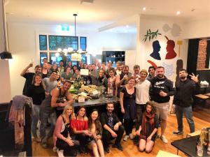 a group of people posing for a picture in a room at The Marion Hostel in Wellington