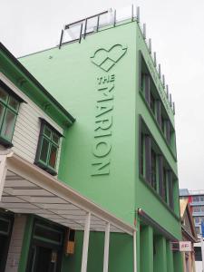 a green building with a heart sign on it at The Marion Hostel in Wellington