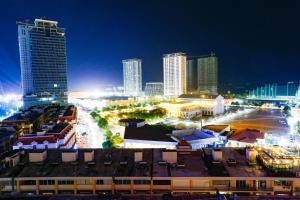 a city skyline at night with tall buildings at Diamond Pearl Hotel ,Phnom Penh,Royel Palace, Mekong RIver,Swimming Pool in Phnom Penh