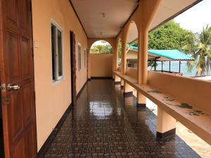 an empty corridor of a building with a hallway leading to the water at Rubtawan Sichang Resort in Ko Si Chang