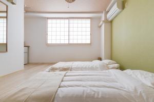 Postel nebo postele na pokoji v ubytování GuestHouse MIYABI