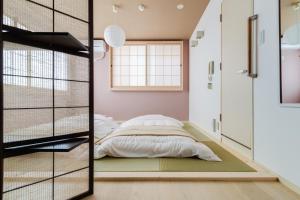 Postel nebo postele na pokoji v ubytování GuestHouse MIYABI