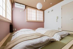 Postel nebo postele na pokoji v ubytování GuestHouse MIYABI
