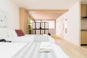 Postel nebo postele na pokoji v ubytování GuestHouse MIYABI