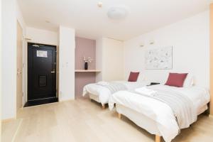 Postel nebo postele na pokoji v ubytování GuestHouse MIYABI