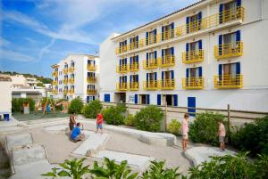 a group of people in front of a building at Bellavista Hotel & Spa in Cala Ratjada