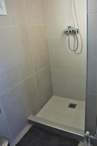 a bathroom with a shower with a glass door at Xenon Loft in Athens