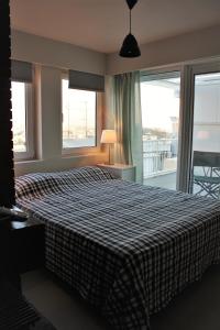 ein Schlafzimmer mit einem großen Bett und einem großen Fenster in der Unterkunft Xenon Loft in Athen