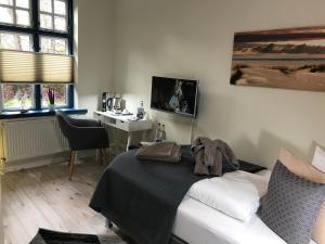 a bedroom with a bed with a stuffed animal on it at Friesenhof Nieblum - Hotel Garni in Nieblum