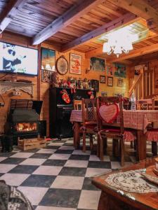 a living room with a fireplace and a table and chairs at Brvnare Mrkic in Kremna