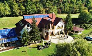 an aerial view of a house with solar panels on it at Brauer Panzió in Mecseknádasd