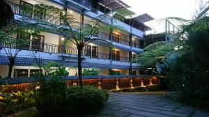 a building with balconies on the side of it at Hotel Kalang Ulu in Berastagi