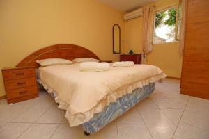 a bedroom with a large bed and a window at Apartments Villa Steffi in Prizba