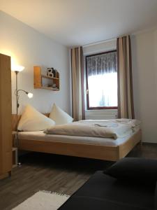 a bedroom with two beds and a window at Penzion Na Solné stezce in Kašperské Hory