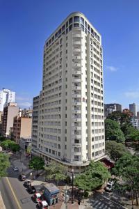 a tall white building in a city at San Raphael Hotel in São Paulo