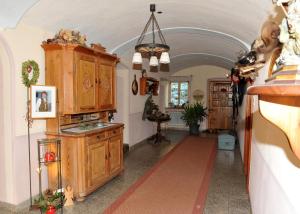 a kitchen with an archway and wooden cabinets at Ferienhof Moyer in Höslwang