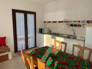 a kitchen with a table with a christmas wrapping on it at Residencial Marcelo e Irene in Florianópolis