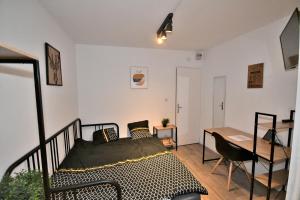 a bedroom with a bed and a table and a desk at Capstay - Trith Netflix in Trith-Saint-Léger +94 photos