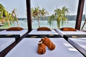 a row of beds in a room with a view of the water at Phi Phi CoCo Beach Resort in Phi Phi Islands